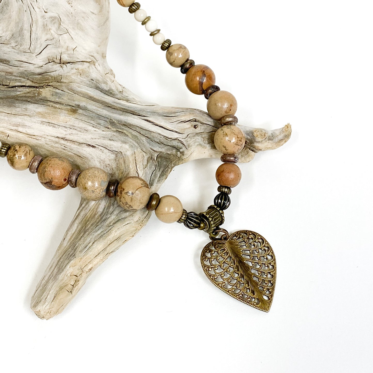 Gemstone of the Earth collection of necklaces by Janice A. Copperstone of Milford, Mich., featuring a bronze or verdigris pendant w/ Jasper (Rugose Corals) beads, a dense, opaque quartz found in Lake Michigan and Lake Superior