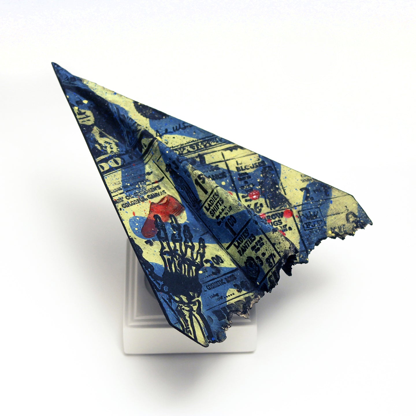 Frank James Fisher's clay paper airplanes are recognizable icons covered in graphics and commentary. 